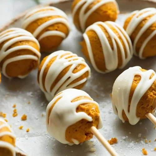 Deliciously decorated Pumpkin Cake Pops on a festive platter for autumn celebrations