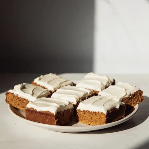 Homemade pumpkin bars topped with cream cheese frosting