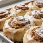 Freshly baked pumpkin butter cinnamon rolls with icing on top