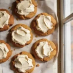 Delicious pumpkin cookies with cream cheese frosting on a plate
